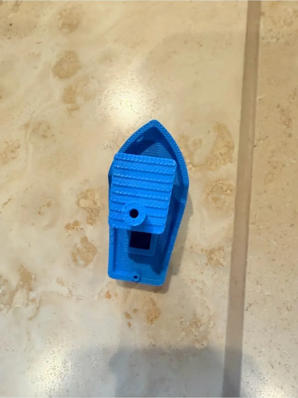 Small 3D-Printed Toy Boat in Bright Blue